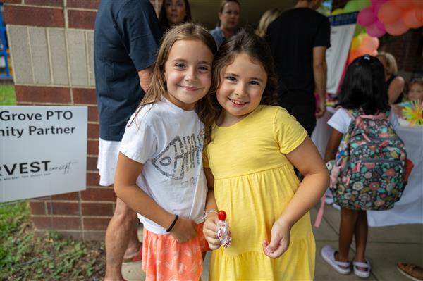 two girls smiling near the WGES entrance